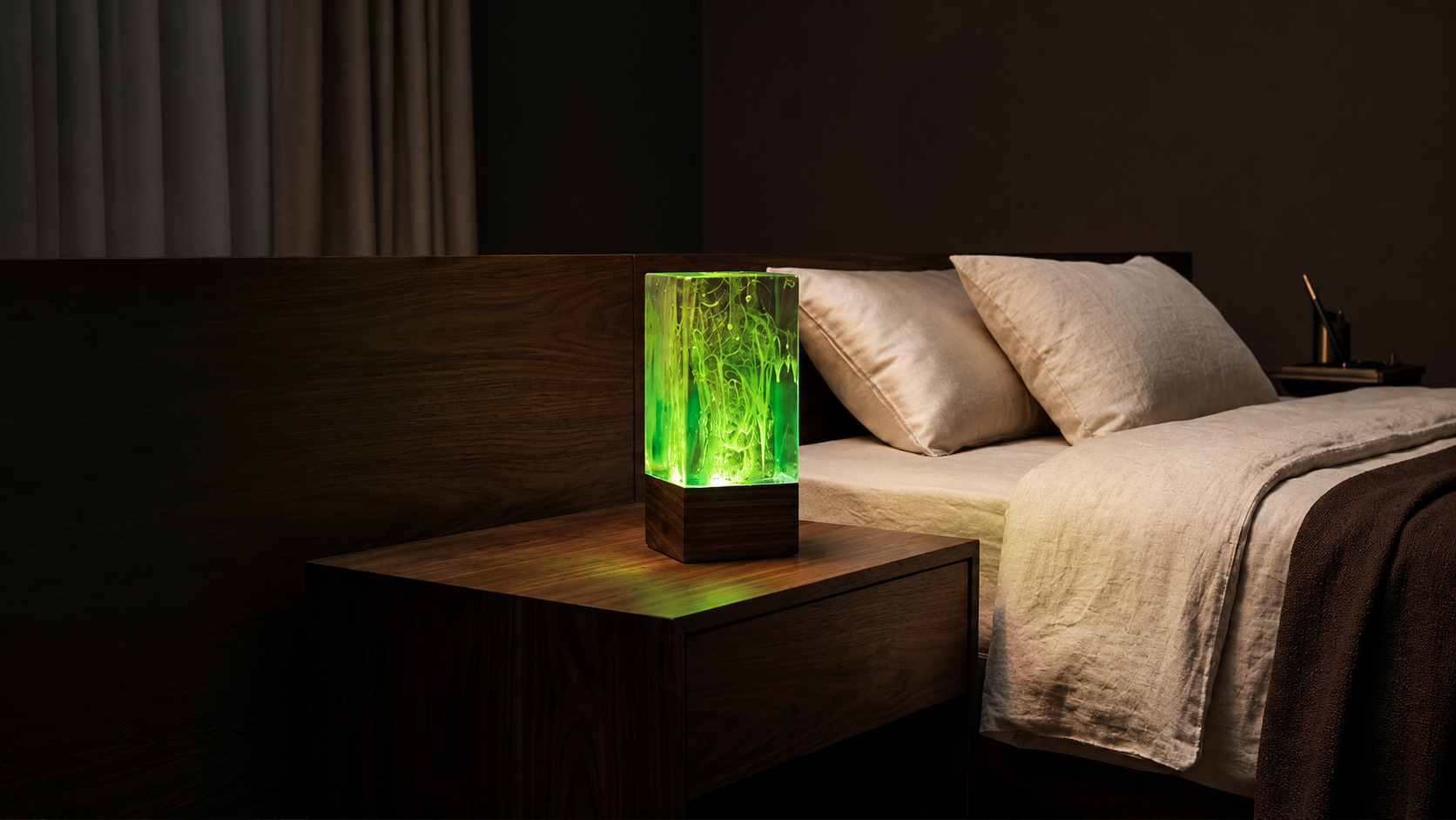 Glowing green AuraRoom resin lamp on a walnut bedside table in a calm luxury bedroom